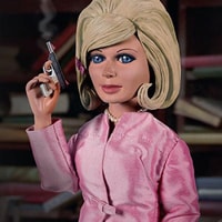 A Lady Penelope doll and a Bionic woman doll with small holdall of  accessories.